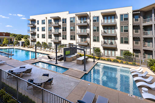 A large apartment complex with a pool.