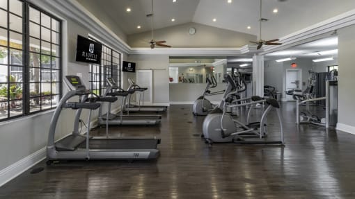 a gym with treadmills and other exercise equipment