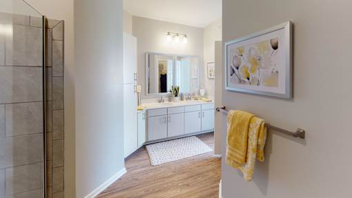 A bathroom with a yellow towel hanging on a towel rack.