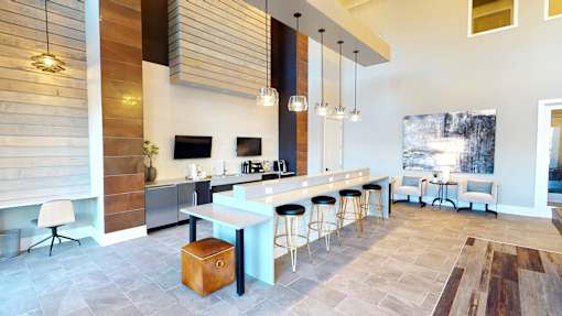 A modern kitchen with a bar area and a dining area.