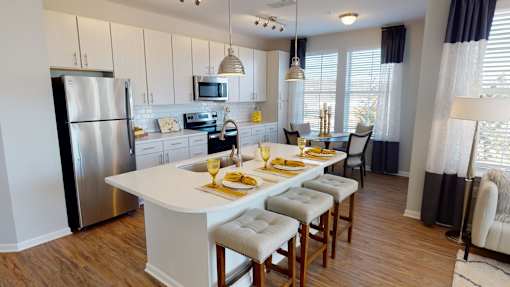 A modern kitchen with a breakfast table set for two.