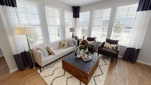 A living room with a couch, chair, and coffee table.