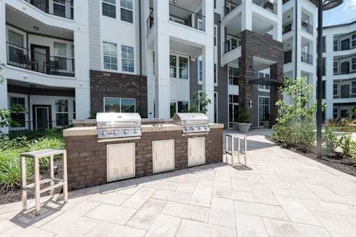A brick wall with a white door and a white bench in front of a building.