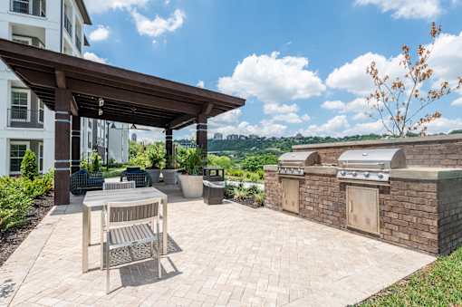 A patio with a table and chairs under a roof.
