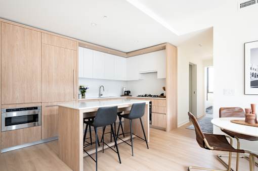 A modern kitchen with a dining table and chairs.