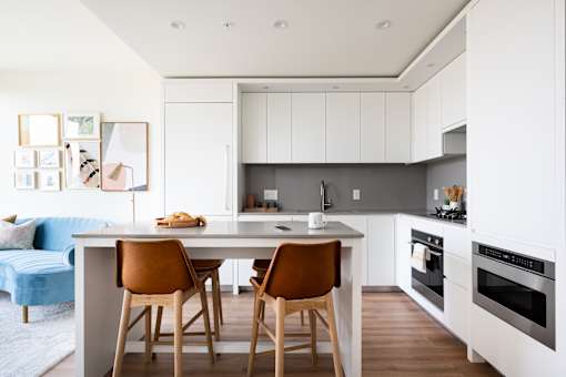 A kitchen with a table and chairs in the middle of it.