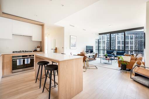A modern kitchen with a bar stool and a countertop.