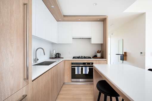 A modern kitchen with wooden cabinets and stainless steel appliances.