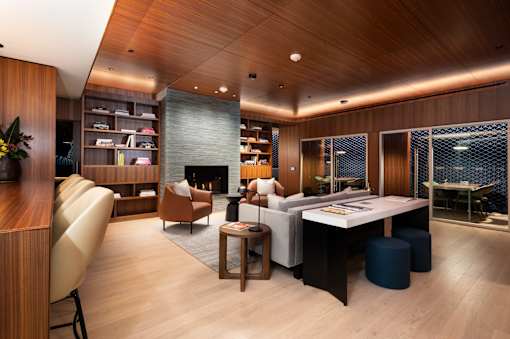 A modern living room with a fireplace and a dining table.