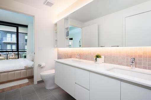 A white bathroom with a toilet, sink, and bathtub.