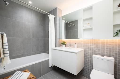 A white bathroom with a white toilet, sink, and bathtub.