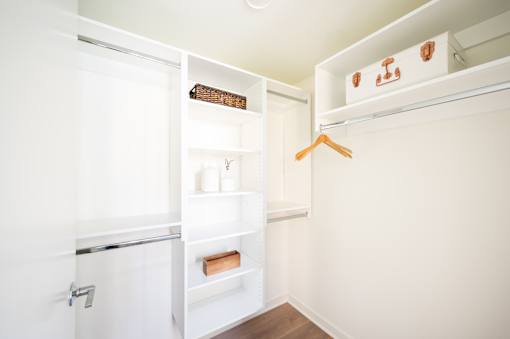 A white closet with a hanger on the right side.