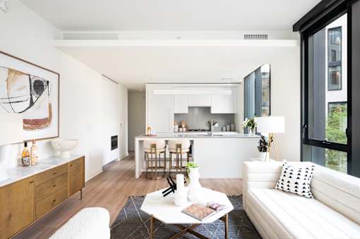 A modern living room with a white couch and a coffee table.