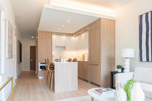 A modern kitchen with wooden cabinets and a white countertop.