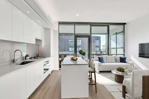 A modern kitchen with white cabinets and a large island.