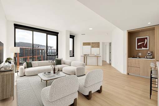 A living room with a white couch and a grey chair.