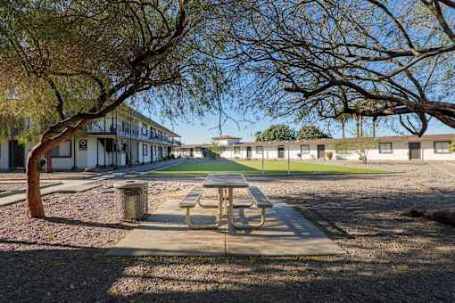 A picnic table is in the middle of a courtyard.