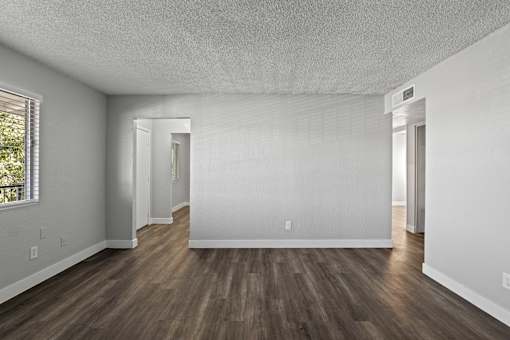 A room with wooden floors and white walls.