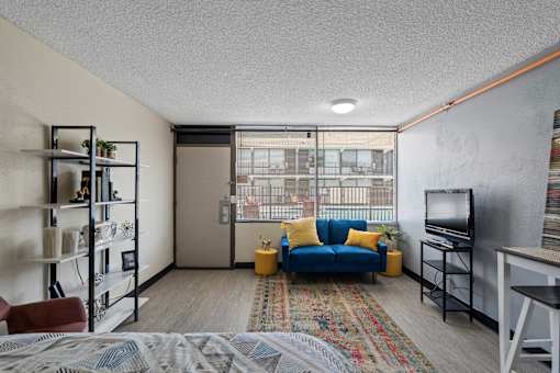 A living room with a blue couch and a television.