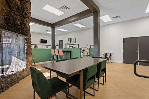 A conference room with a long table and chairs.