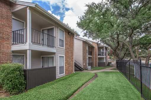Apartment building with a green lawn in front.