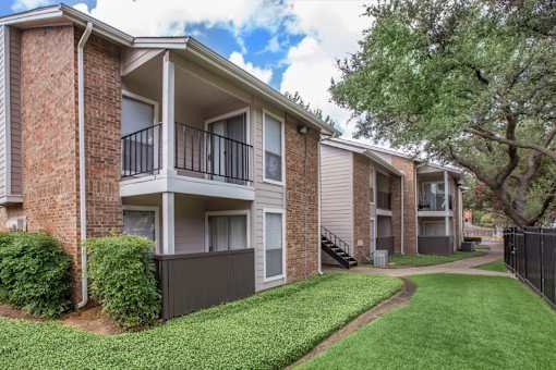 Apartment complex with a green lawn in front.