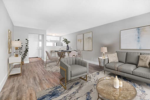 a living room with a couch and chairs and a dining room table
