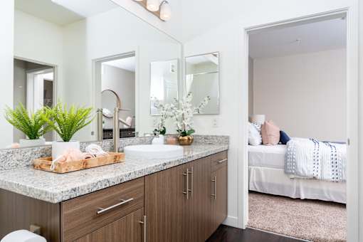 A bathroom with a white sink and a mirror above it.