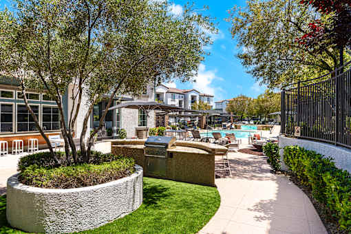 A beautifully landscaped outdoor area with a swimming pool and lounge chairs.