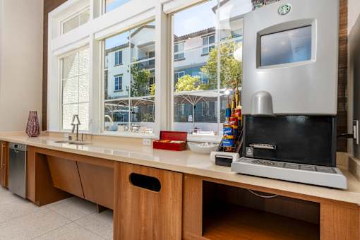 A modern kitchen with a coffee machine on the counter.