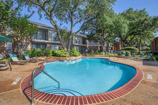 A small pool surrounded by a brick border.