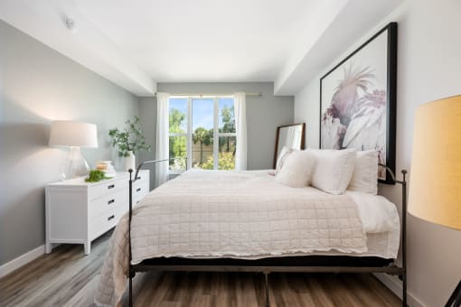 a bedroom with a large bed and a window