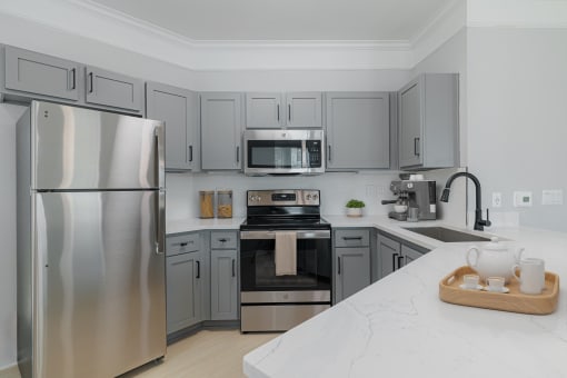 a kitchen with stainless steel appliances and marble counter tops