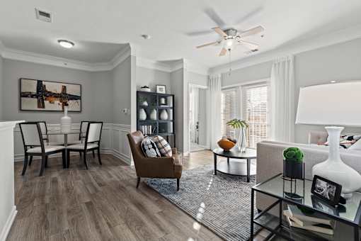 A living room with a brown chair and a white lamp.
