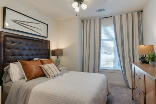 Model Bedroom with Bed and Nightstands and Large Window at Hermosa Village, Leander, TX