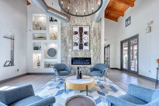 A living room with a fireplace and a chandelier.