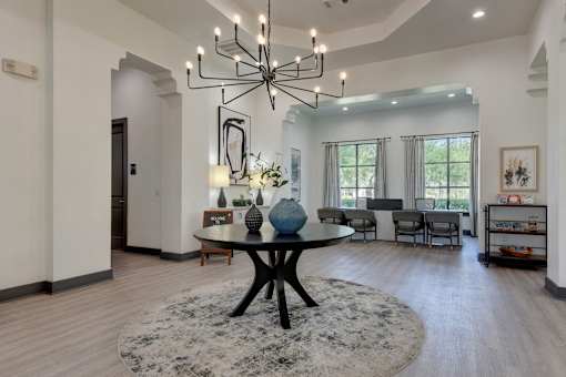 A modern dining room with a large table and chairs.