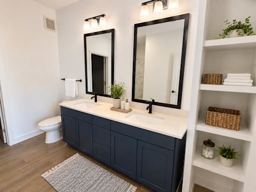 A bathroom with a white sink and a mirror above it.