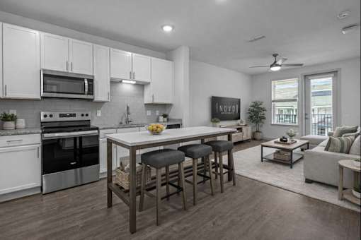 A modern kitchen with white cabinets and a large island.