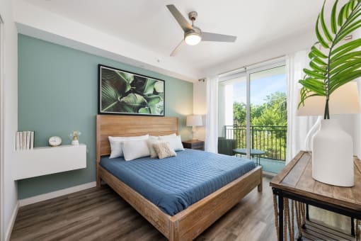 a bedroom with a bed and a ceiling fan