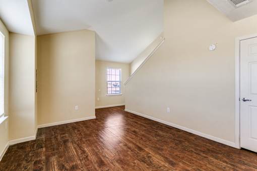 A room with wooden floors and a window.