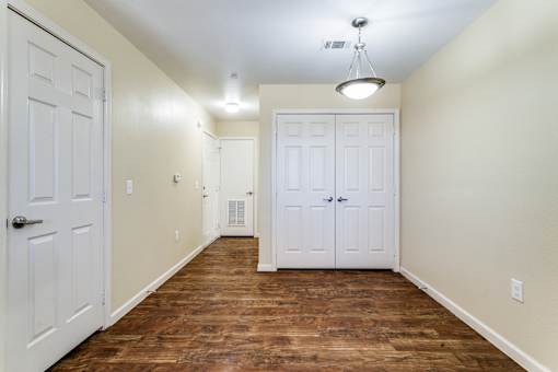A room with a white door and a white closet door.