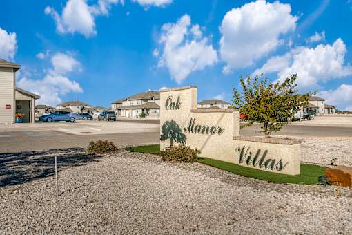 A sign that says "Culver Villas" is in front of a building.