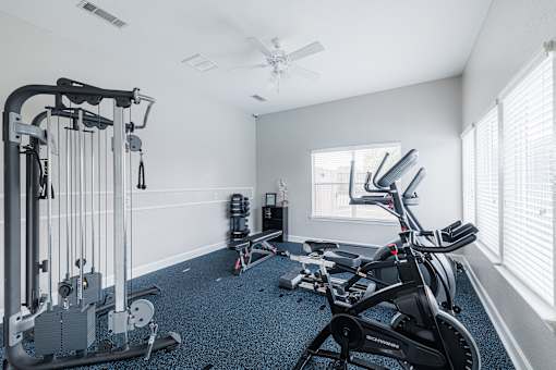 A spacious home gym with a variety of exercise equipment.