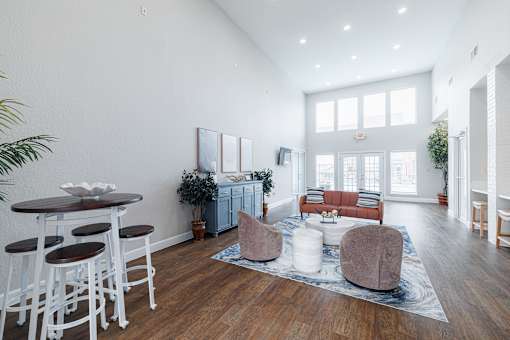 A living room with a white table and chairs.