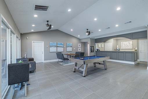 A room with a pool table and a billiard table.