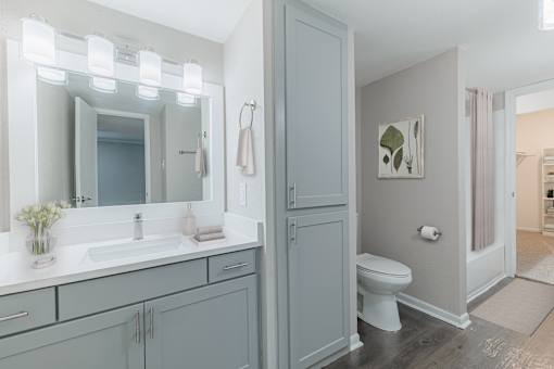 A bathroom with a white sink and a toilet.