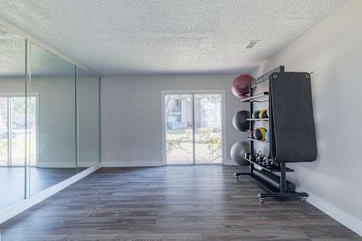 A room with a sliding glass door and a wooden floor.