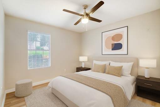 A bedroom with a large bed, a ceiling fan, and a window with blinds.