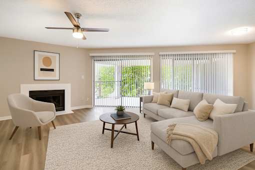 A living room with a fireplace, a chair, a couch, and a coffee table.